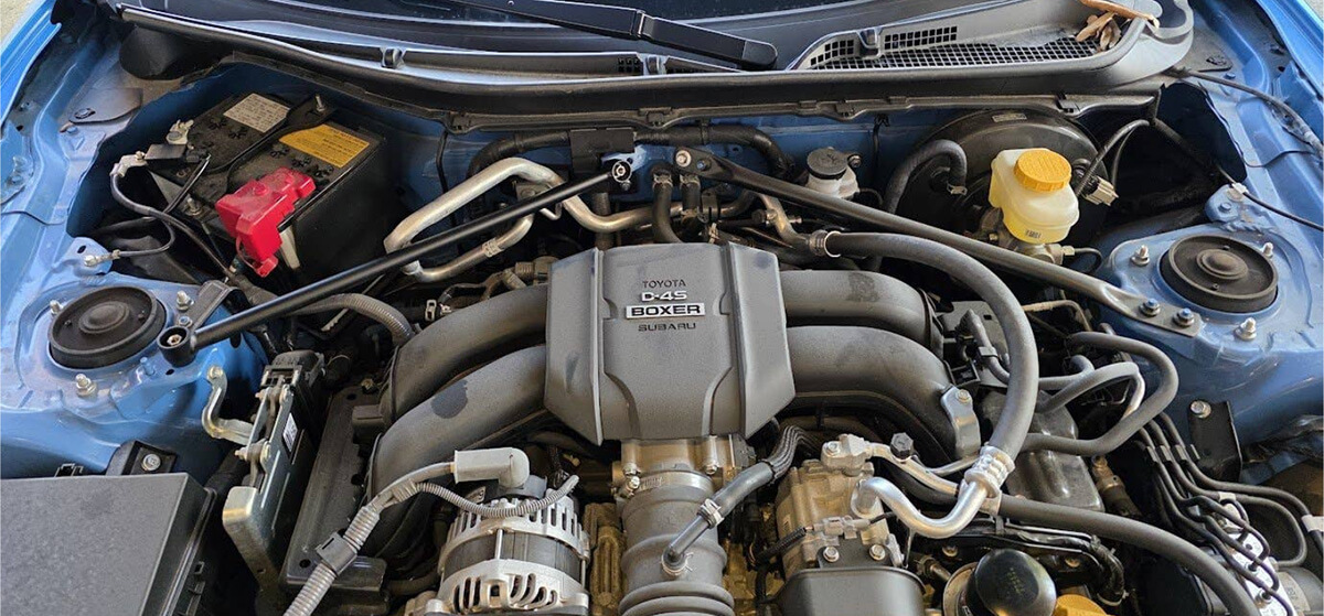 Comparison of Nameless Performance firewall V-brace vs stock flimsy OEM brace on a Toyota GR86.